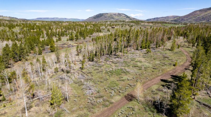 Aerial Photo Showing the Dirt Road with Woodchuck Hill on the Background for Lot 150 Sky Hitch II At Stagecoach