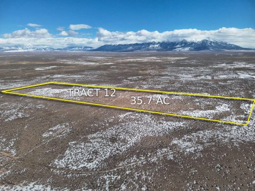 Drone shot of the property showing the parcel lines and mountains in the near background