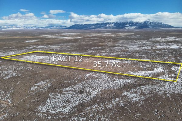 Drone shot of the property showing the parcel lines and mountains in the near background